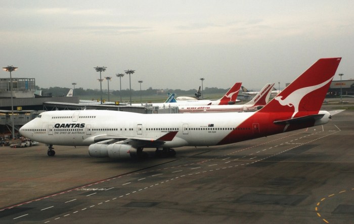 White and Red Qantas Airplane Fly High Under Blue and White Clouds ... Australias qantas close low cost arm jetstar asia